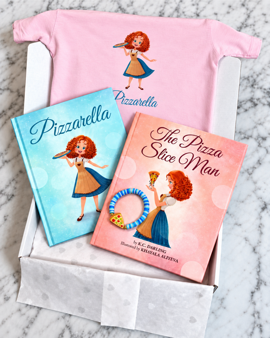 gift set in white box on marble table, includes pink shirt, 2 books, blue bracelet