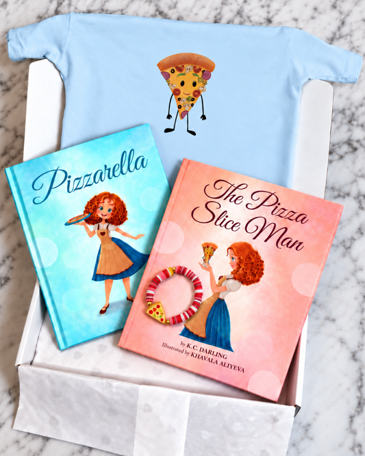 A children's gift box on a marble surface containing a light blue t-shirt with a cartoon pizza slice character, a blue hardcover book titled 'Pizzarella', and a pink hardcover book titled 'The Pizza Slice Man'.
