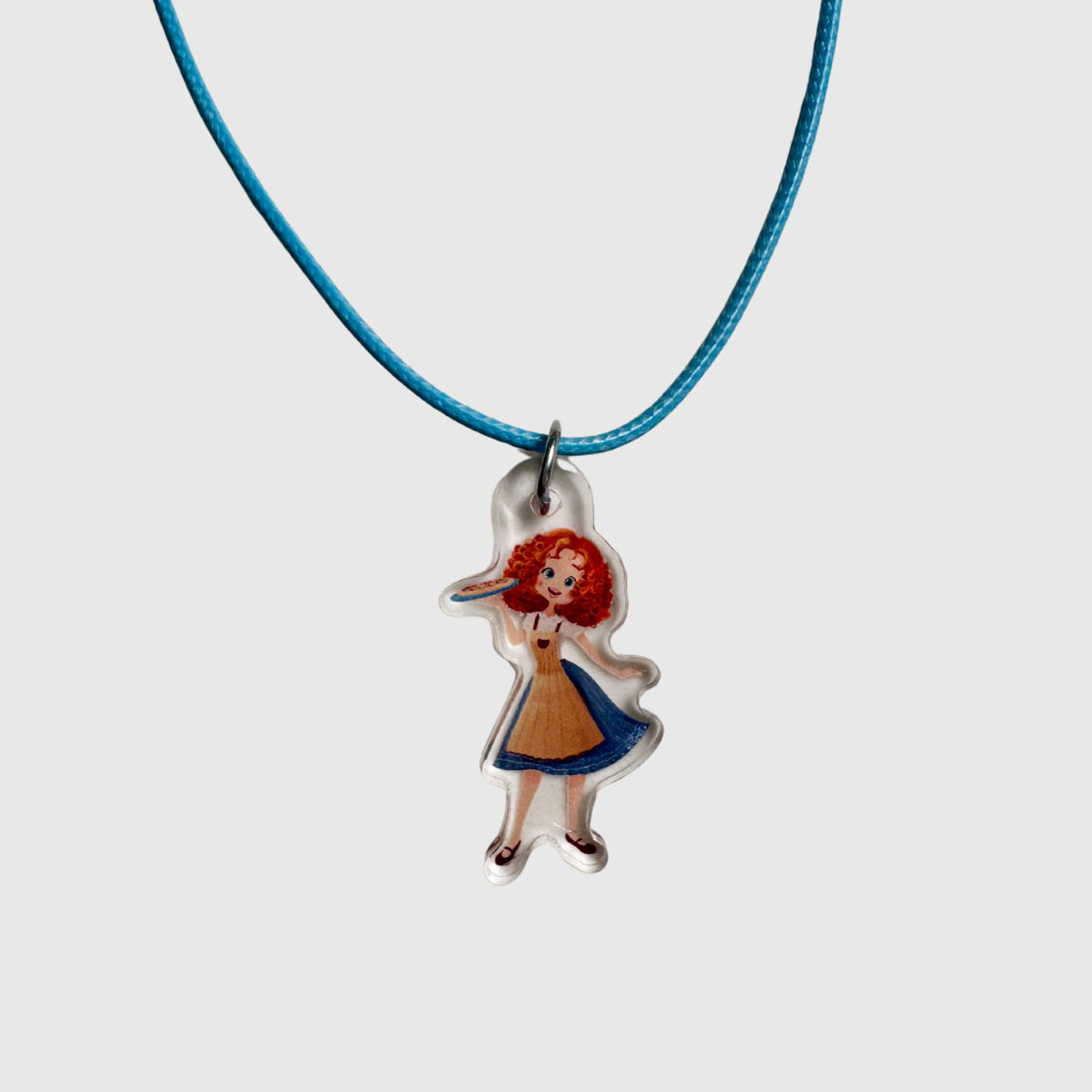 Necklace with a pendant of a girl in a dress on a white background