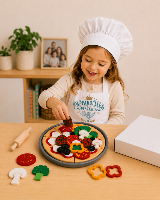 Girl in apron and hat playing with a felt pizza toy